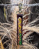 Leather keychain with floral design on a natural background