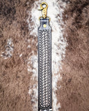 Leather strap with basketweave design on a fur background