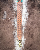 Snap of a purse strap laying on cowhide