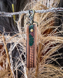 Decorative leather strap with intricate designs on a textured background