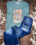 Tee laying on Cowhide rug with blue jeans 
