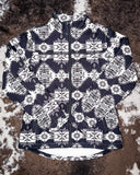 The Aztec City Soft Shell Jacket displayed on cowhide.