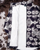 The Aztec City Soft Shell Jacket displayed on cowhide. It is open to show the inside of the jacket, which is white.