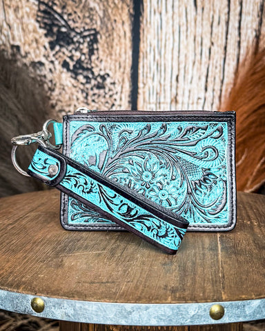The Prickly Pears Card Holder in Turquoise displayed on a wooden table with wheat in the back, sitting in front of a wood back drop.