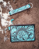 The Pride of Prickly Pears Card Holder and wristlet strap displayed on cowhide.