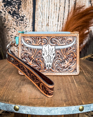 The Pride of Prickly Pears Card Holder in Dark Brown displayed on a wooden table with wheat in the back ground, sitting in front of a wood back drop.