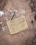 The Outlander Edge Credit Card Holder in Brown displayed on cowhide.