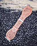 The Lone Star Hand Tooled Leather Watch Band in Light Saddle Tan displayed on beans and wheat.