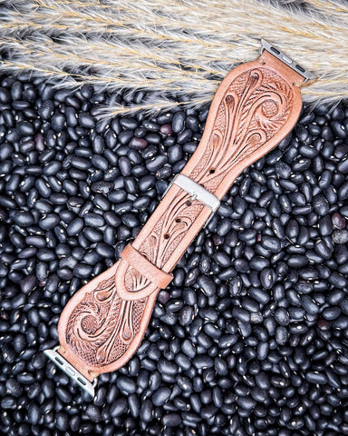 The Lone Star Hand Tooled Leather Watch Band in Light Saddle Tan displayed on beans and wheat.