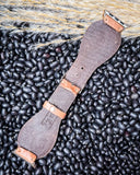 The back of the Lone Star Hand Tooled Leather Watch Band in Light Saddle Tan, displayed on beans and wheat.