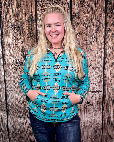 A model wearing the Laramie Kreek Fitted Pullover in a wood back ground.