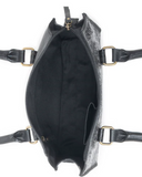 Black leather handbag with brass hardware on a white background