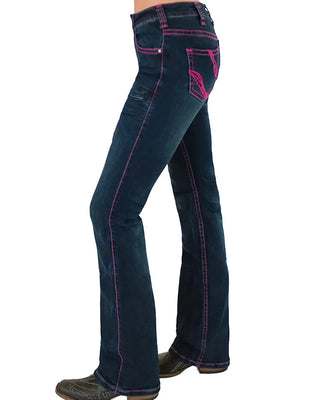 A side profile view of a person wearing dark blue flare jeans with bright pink contrast stitching and matching pink embroidery on the back pocket, paired with dark brown boots against a white background.