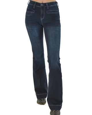 Dark blue denim flare jeans shown on a model from the waist down, featuring a straight-to-flared leg and contrast stitching, paired with brown shoes against a white background.