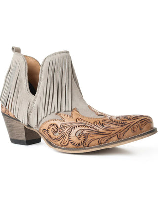 Pair of beige cowboy boots with fringe and intricate brown leather design on a white background