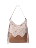Rustic western handbag with floral tooled leather displayed on white background