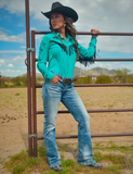 Model wearing boot cut jeans in front of a fence.