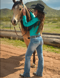 Back view of model wearing boot cut jeans in front of a fence with a horse.