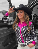 A cowgirl standing by a truck wearing the Sweet Spot Pullover Button Up With Hot Pink Satin Accents.