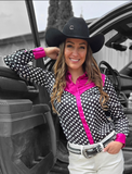 A cowgirl standing by a truck wearing the Sweet Spot Pullover Button Up With Hot Pink Satin Accents.