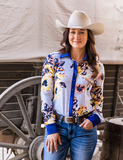 A cowgirl wearing the Sweet Bluebell Breeze Pullover Button Up in front of a wagon.