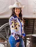 A cowgirl wearing the Sweet Bluebell Breeze Pullover Button Up in front of a wagon.