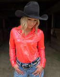 A cowgirl wearing the Rind and Shine Pullover Button Up in a barn.