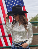 Front view of a model wearing the  Shiny Side Up Pullover in front of the American flag and a fence.