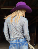 Back view of a model wearing the  Steel Serpent Pullover in a barn.