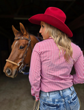 Back view of a model wearing the Sugar and Grit Pullover in front of a horse.