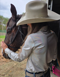 Side view of a model wearing the Desert Hound Pullover next to a horse.