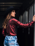 Back view of a model wearing the  Spurfire Pullover inside of a trailer.