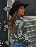 Back view of a model wearing the Spurfire Pullover Button up in front of a trailer.