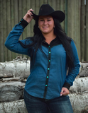 Model posing in front of logs wearing the Ranch Ready Pullover Button Up.