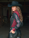 Model posing in a barn wearing the Never Give Up Pullover Button Up.