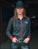 Front view of the model posing in a barn wearing the Never Give Up Pullover Button Up.