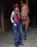 Model wearing the Cowgirl Tuff Pull-On Star Trouser holding a horse.