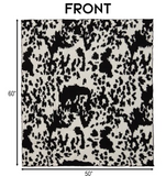 Cow print blanket with dimensions on a white background.