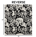 Cow patterned blanket with dimensions on a white background.