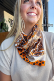 Model smiling wearing a wild rag.