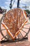 Wild rag laying over a wagon wheel.