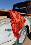 Wild rag draped over a rusty truck