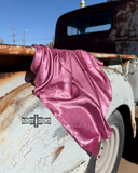 Wild rag draped over a rusty truck