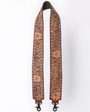 Decorative leather purse strap with intricate patterns on a white background