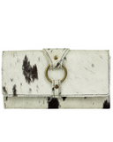 White wallet with black cow print pattern on a white background