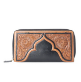 Black leather wallet with intricate brown tooled designs on a white background