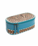Blue jewelry box with intricate tooled designs on a white background