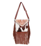 The Straybird Hair on Hide Fringe Crossbody Bag in a white back ground.
