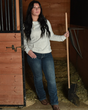 Model wearing Cowgirl Tuff Denim Flannel Jeans in barn stall 