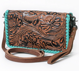 Brown leather crossbody bag with intricate floral patterns and turquoise accents on a white background